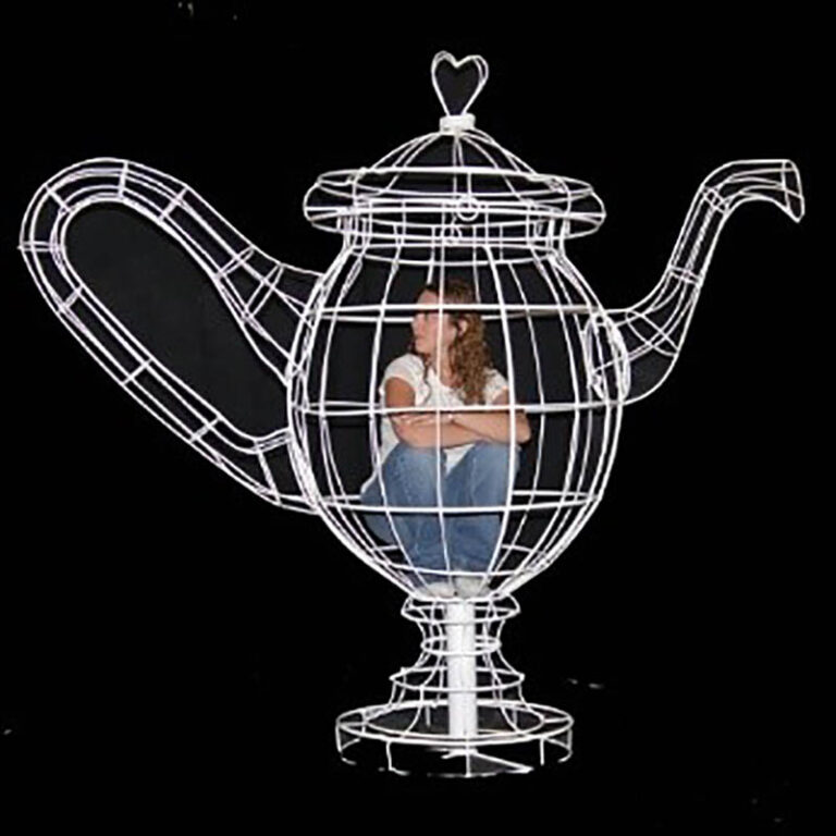 3d art of a wireframe teapot with a human inside