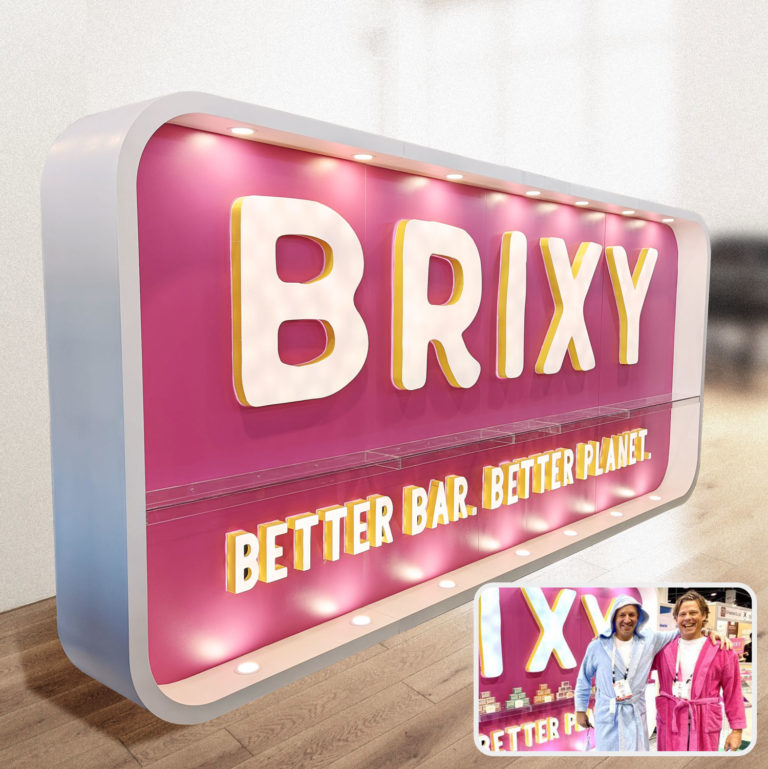 8'x18' custom lighted display trade show booth, complete with shelves to hold products.