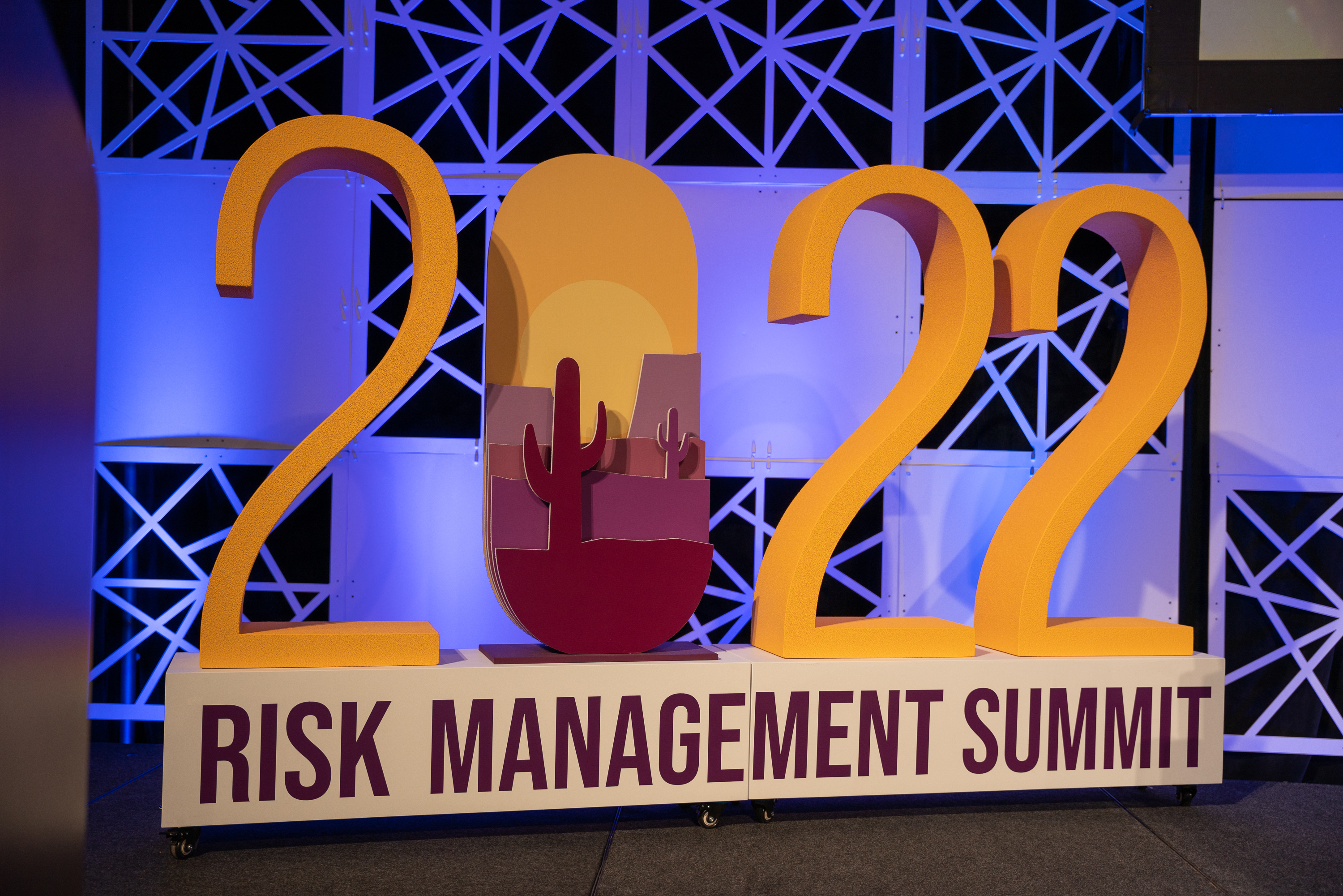 eMaxx Summit 2022 event display with large foam letters and graphic vinyl faces.