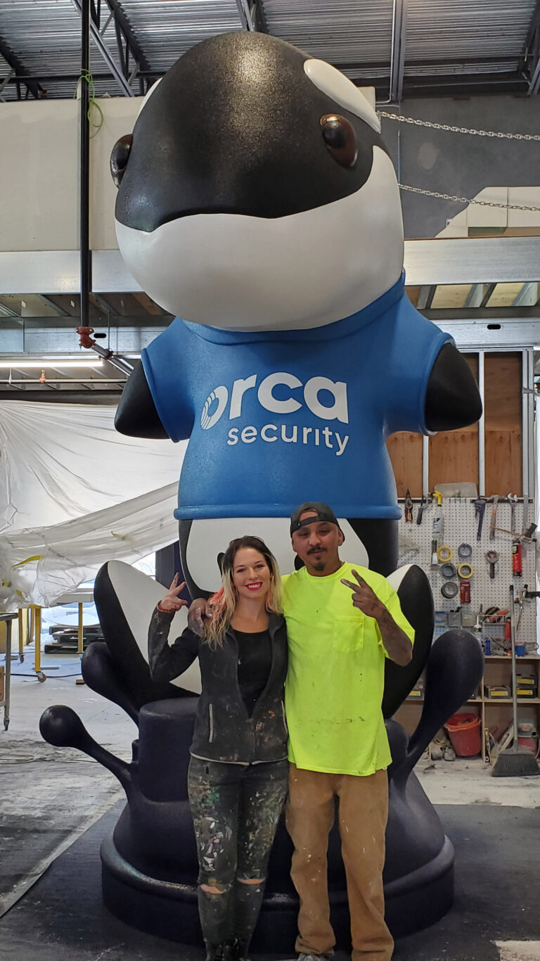 Giant Orca whale company mascot foam statue with sculptor and painter at WhiteClouds before shipping