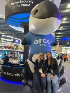 Orca Security team at tradeshow with the foam company mascot sculpture