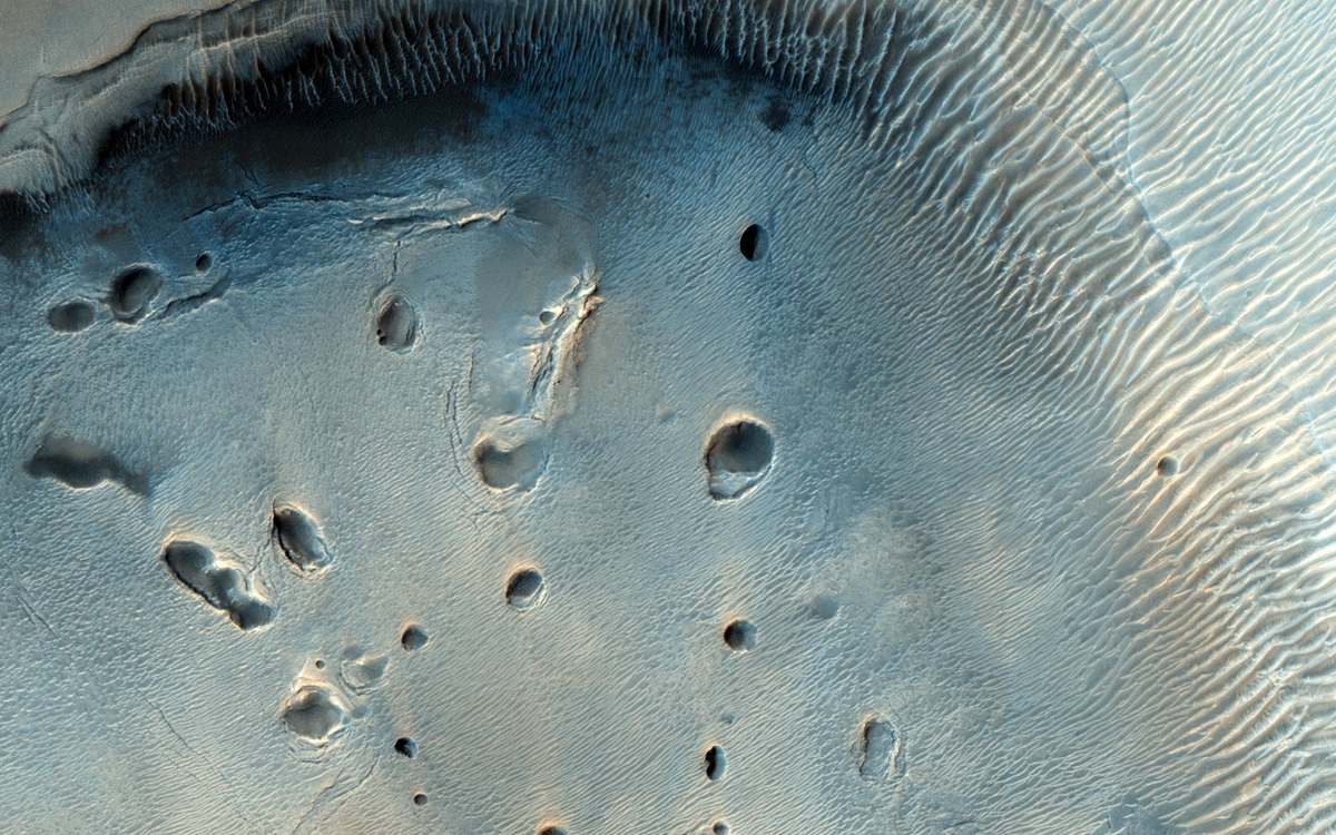 A Dark-Toned, Pitted Mound in a Crater in Northeast Arabia Terra
