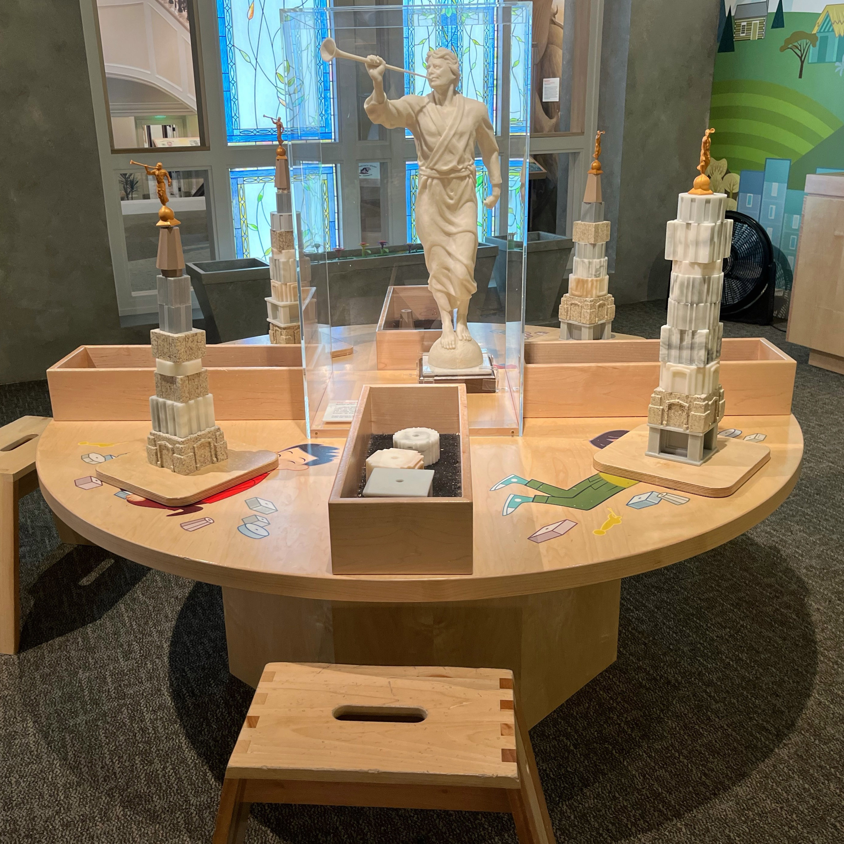 Colorful 3D-printed temple building blocks arranged as an educational exhibit.