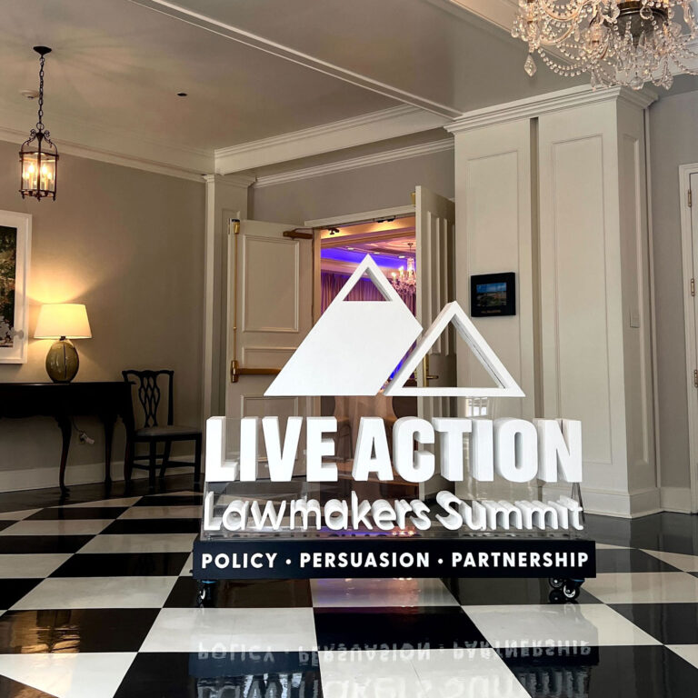 Floating logo display fabricated with clear acrylic backing for Live Action Summit.