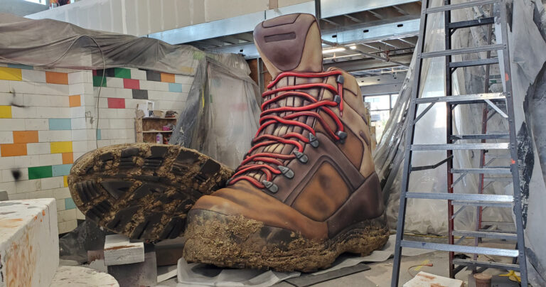 3D relief muddy hiking boot props fabricated for a billboard in Flagstaff.