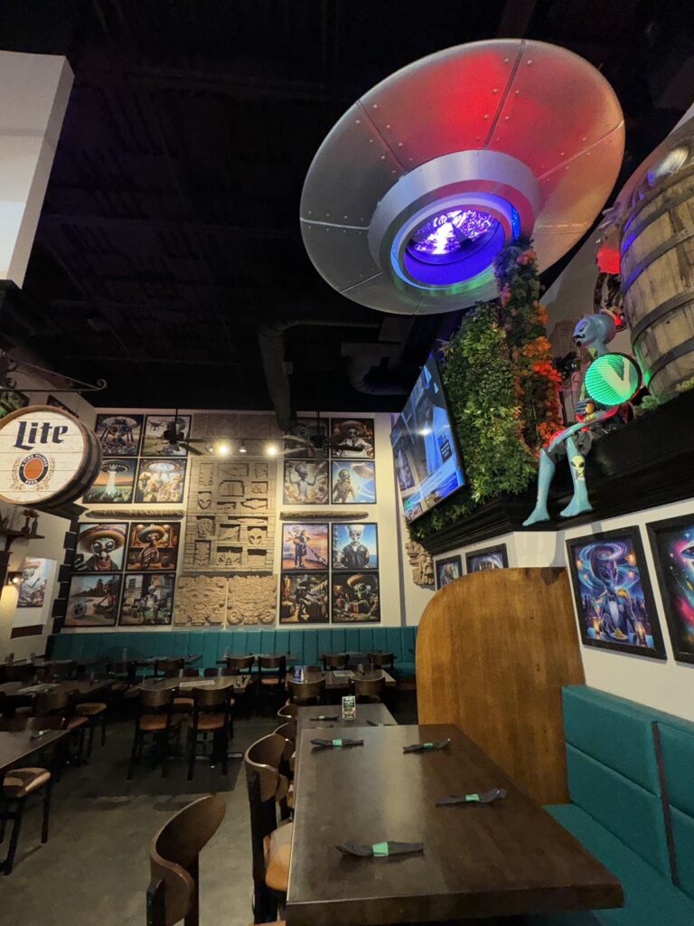 UFO prop installed above the Alien Taco bar area