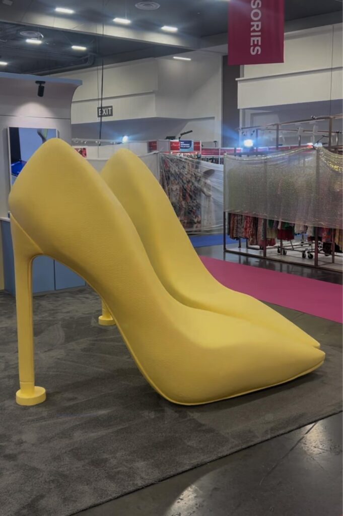 Pair of giant yellow high-heel shoe chairs at a Walmart Marketplace event
