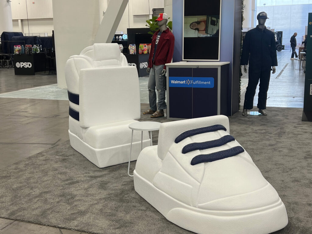 White giant tennis shoe chair props at a Walmart Marketplace expo