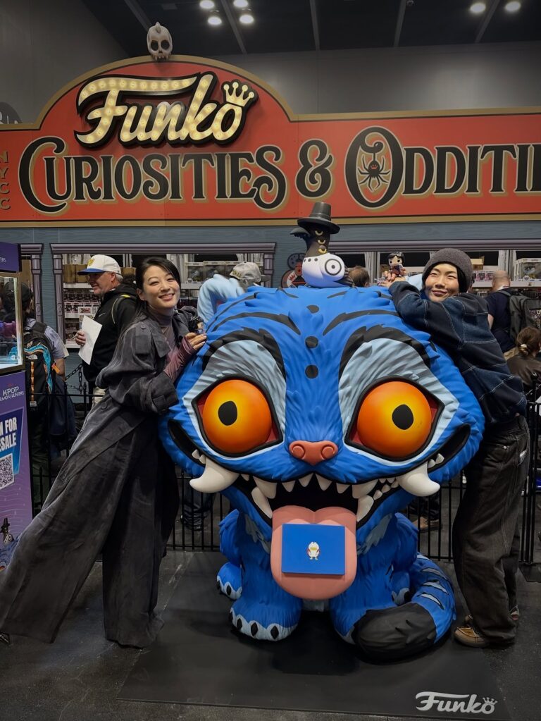 NYCC Funko booth Derpy Tiger statue pictured with Arden Cho (acting voice of Rumi) and May Hong (acting voice of Mira) from KPop Demon Hunters!