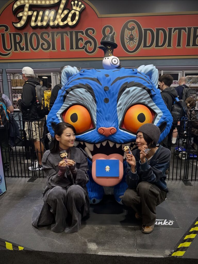 NYCC Funko booth Derpy Tiger statue pictured with Arden Cho (acting voice of Rumi) and May Hong (acting voice of Mira) from KPop Demon Hunters!