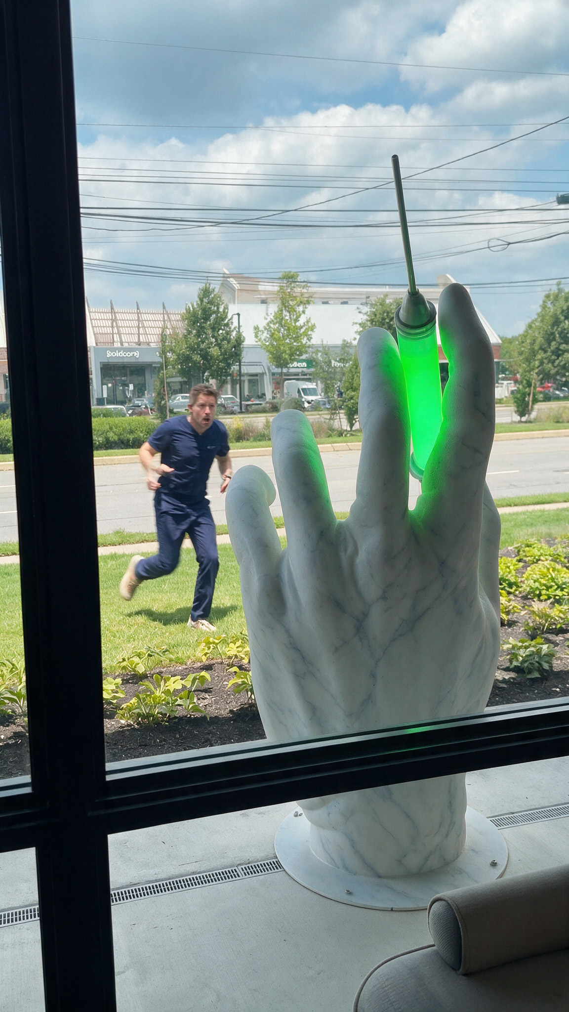 Custom Giant Marble-Style Hand Statue with LED Syringe.