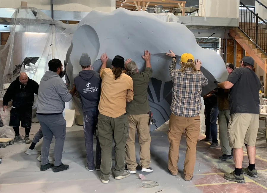 WhiteClouds team moving a large nutcracker section through the production facility