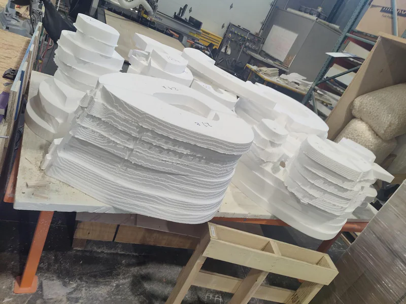 Rough-cut foam sections establishing the main shape of a shark sculpture.