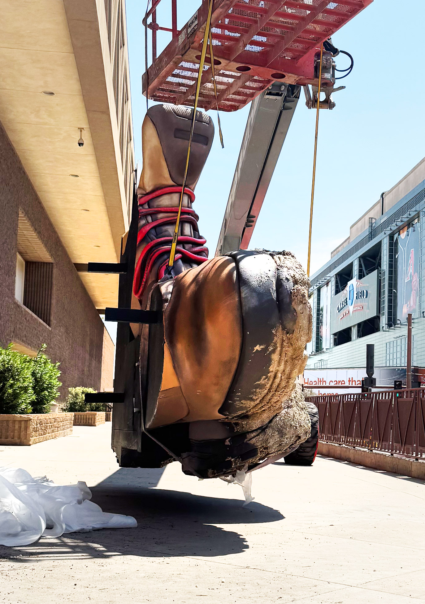 Side view showing the flat-back construction of a giant hiking boot billboard prop